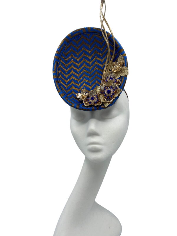 Blue and gold chevron detail percher with gold flower and quill detail.